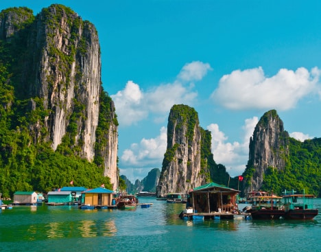 Fischerboot zwischen Karstfelsen in der Halong-Bucht
