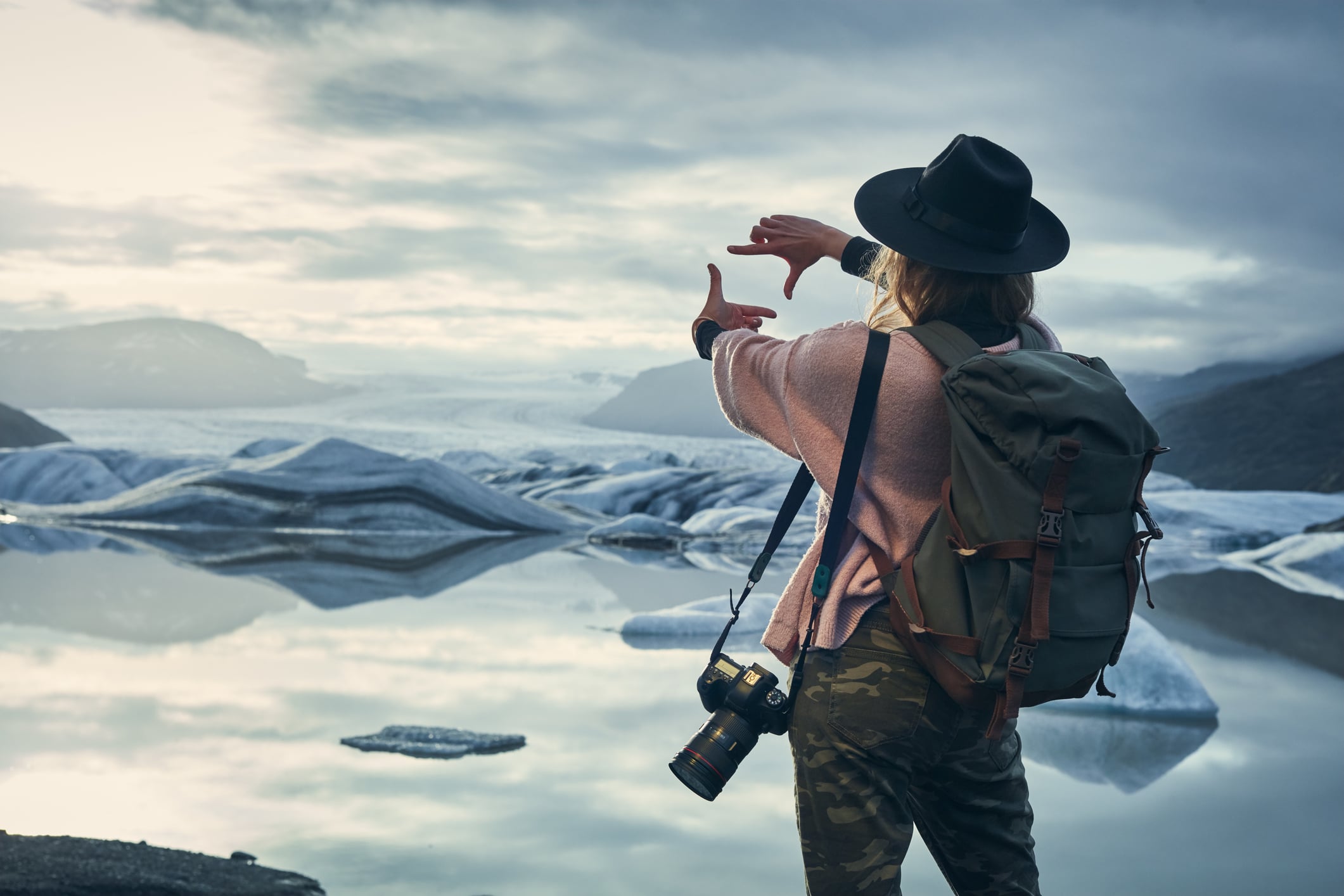 Reisende fotografiert eine Gletscherlandschaft auf einer individuell geplanten Rundreise