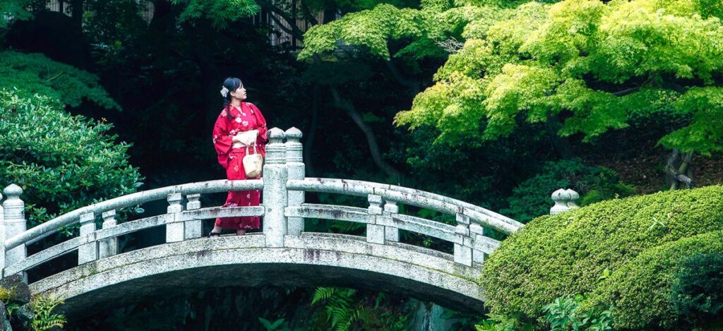 Frau überquert Brücke in Japan