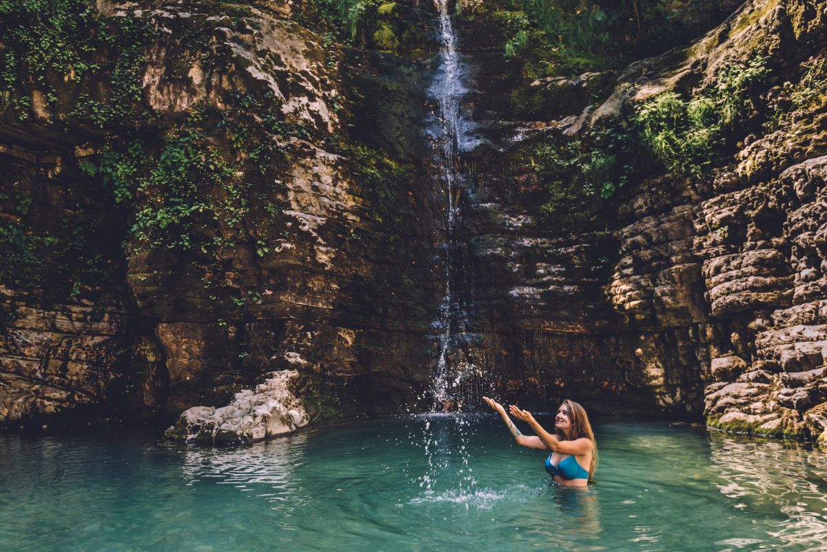 Frau genießt die versteckten Wasserfälle im Nivica Canyon, Albanien