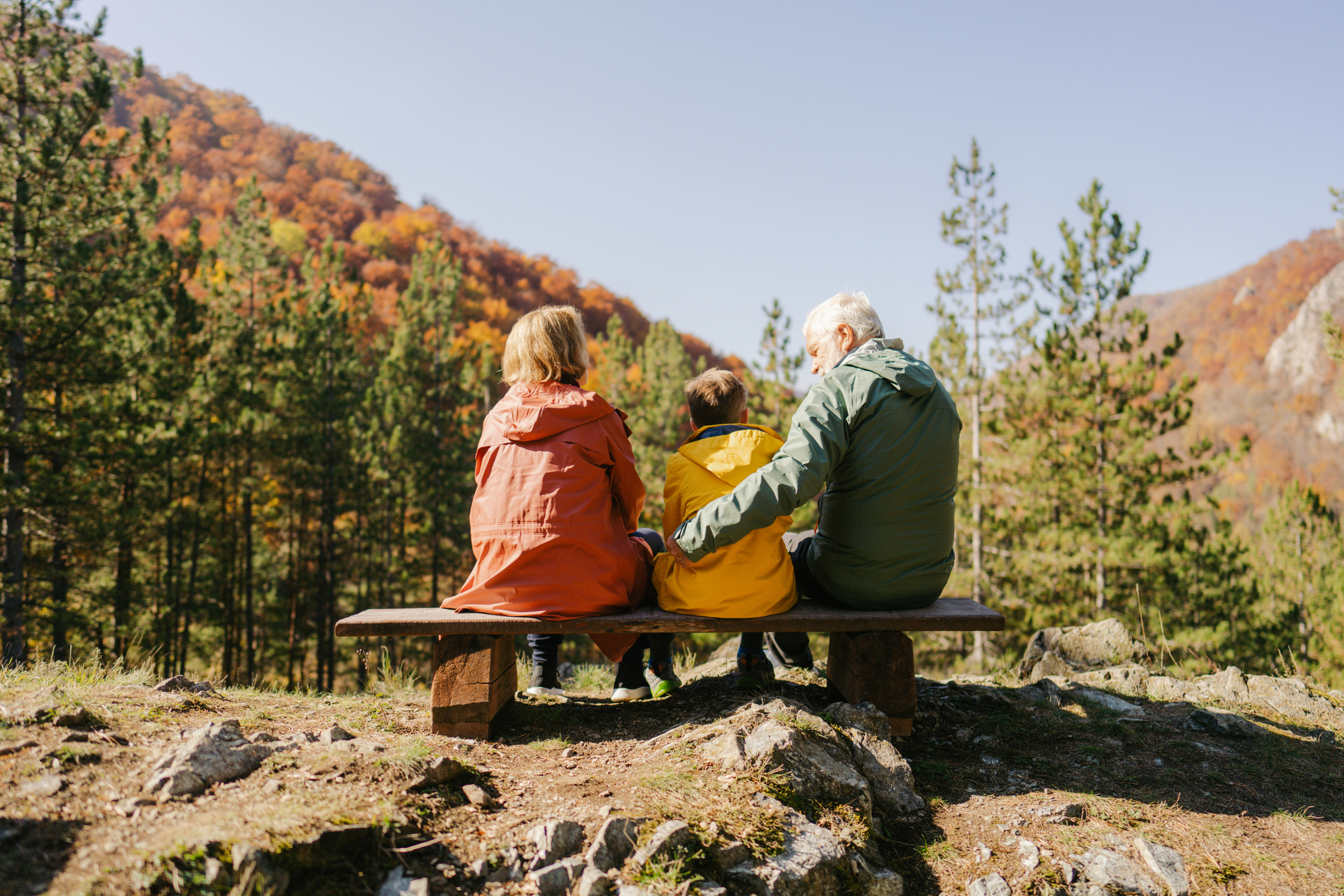 Großeltern und Enkel, die einen schönen Blick auf den Wald genießen.