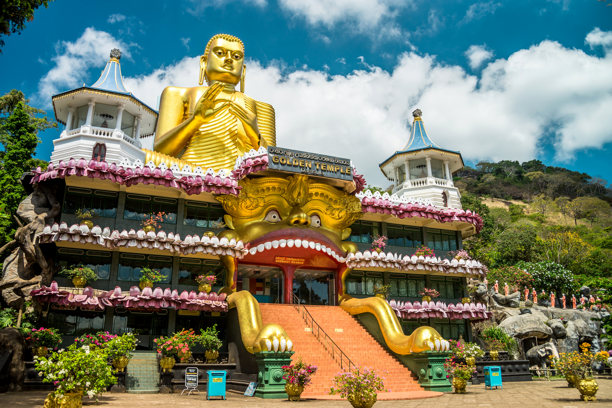 Goldene Buddhastatue über dem Tempelgebäude in Dambulla