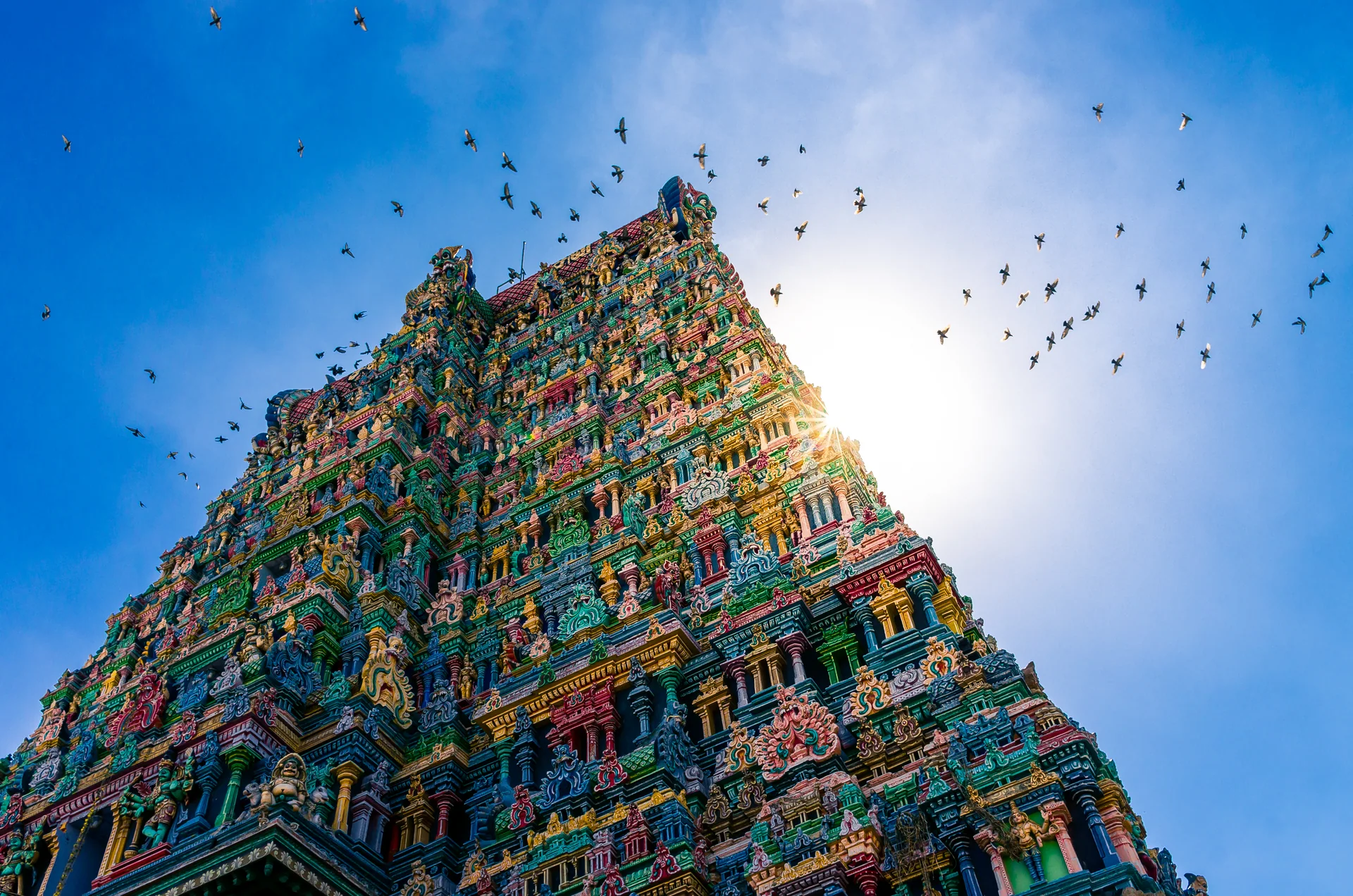 Farbenreicher Gopuram des Meenakshi-Tempels in Madurai vor blauem Himmel